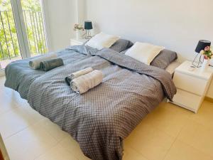 a bed with two pillows on it in a bedroom at Apartment Lucy Hacienda Riquelme Golf resort in Murcia