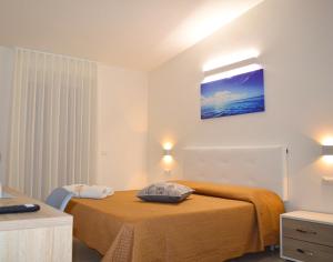 Postel nebo postele na pokoji v ubytování Valle degli Ulivi B&B