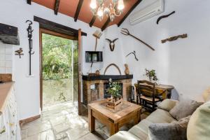 een woonkamer met een bank en een open haard bij Apartamento Cortijo Rural Las Aves in Jimena de la Frontera