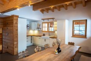 a kitchen with a wooden table in a room at Ski in & out Chalet Marmo in Zermatt in Zermatt