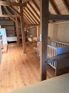 a large room with wooden floors and wooden beams at Begijnhof 9 in Sint-Truiden