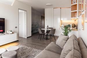 a living room with a couch and a table at Bright Kaunas apartment with Castle view in Kaunas