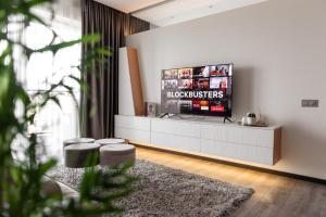 a living room with a flat screen tv on a wall at Bright Kaunas apartment with Castle view in Kaunas