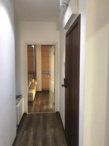 a hallway with a door leading to a living room at Lilia 2 Self-Check in apartment in Sofia +22 photos