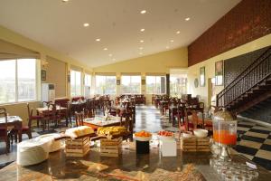 a restaurant with tables and chairs in a room at Spree Resort Sariska in Thāna Ghāzi