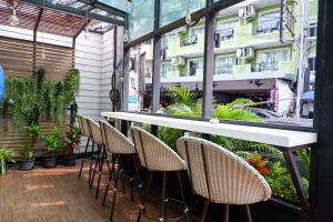 a row of chairs and a bar on a patio at 18 Coins Budget Hotel in Pattaya Central