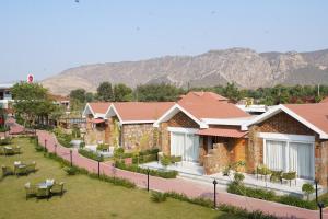 a row of houses with mountains in the background at Spree Resort Sariska in Thāna Ghāzi