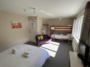 a bedroom with a bed and a bedroom with a bunk bed at Strathassynt Guest House in Glencoe
