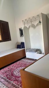 a room with two beds and a red carpet at ACM Flat in Natal