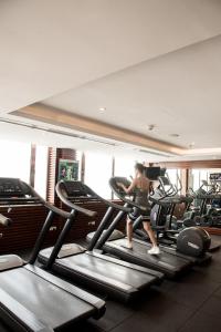 a woman running on a treadmill in a gym at Windsor Plaza Hotel in Ho Chi Minh City