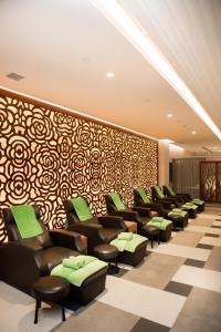 a waiting room with chairs and a patterned wall at Windsor Plaza Hotel in Ho Chi Minh City