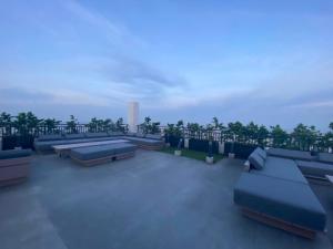 a rooftop with couches and tables on a roof at Studio With balcony in Carreta