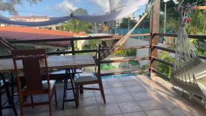 a hammock on the balcony of a house at ACM Flat in Natal