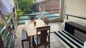 a balcony with a table and chairs and a pool at ACM Flat in Natal