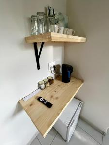 a wooden table with a shelf on a wall at Wamelia Guesthouse in Bloemfontein