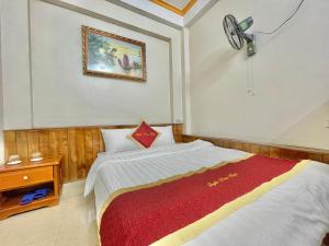 a bedroom with a bed and a clock on the wall at Happy Hotel & Spa in Sapa