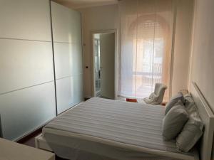 a bedroom with a large bed with a window at Adua Flat - perfect place for visiting Tuscany in Pistoia