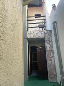 a hallway of a building with a door and a balcony at ACM Flat in Natal