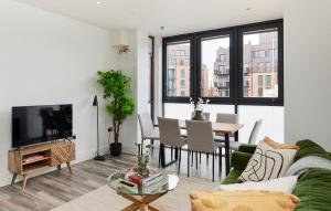 a living room with a couch and a table at The Wembley Hideaway - Bright 2BDR Flat in London