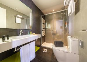 a bathroom with a toilet and a sink and a shower at Hotel Cristina in Pas de la Casa