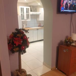 a kitchen with a christmas wreath on the floor at Dom pod Jodłami in Lubawka