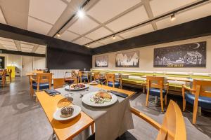 a restaurant with tables and chairs with food on them at Hotel Cristina in Pas de la Casa
