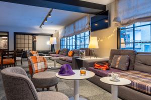 a living room with a couch and tables and chairs at Hotel Cristina in Pas de la Casa