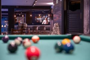 a pool table with balls in front of a bar at Hotel Cristina in Pas de la Casa