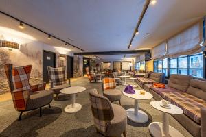 a living room with a couch and tables and chairs at Hotel Cristina in Pas de la Casa