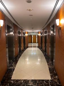 a hallway of a building with a hallway of elevators at Amazing Double Room with En-suite, Marina and Sea views with shared kitchen in Dubai