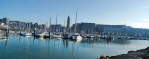 a group of boats docked in a harbor with buildings at Vivez l'Horizon sur la mer - Vue mer - plage - Port de plaisance in Le Havre