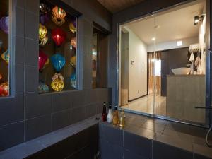 a bathroom with a tub and a shower with a glass window at Adan Resort 燈 - LANTERN - in Bise +38 photos