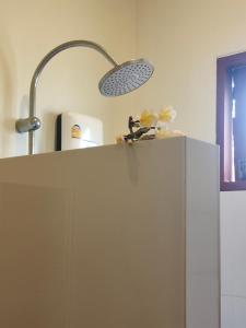 a kitchen with a light on top of a refrigerator at Links Sunset Beach House in Amphoe Koh Samui +63 photos