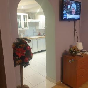 a kitchen with a christmas wreath and a television on a wall at Dom pod Jodłami in Lubawka