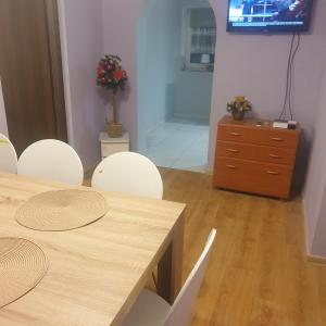 a dining room with a table and chairs and a tv at Dom pod Jodłami in Lubawka