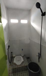 ein kleines Bad mit einem WC und einer Dusche in der Unterkunft SPOT ON 93428 Pinus Jaya Syariah in Palas 2