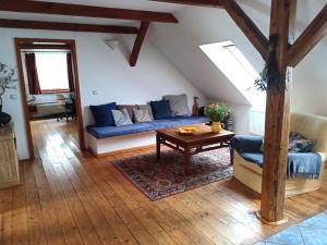 a living room with a blue couch and a table at Family apartment Vysočina SKI plus BIATLON in Nové Město na Moravě