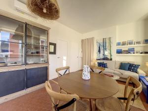 a living room with a wooden table and chairs at Nestor&Jeeves - REVE BLEU - View Port - BALCONY in Nice