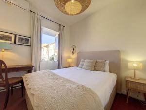 a bedroom with a white bed and a window at Nestor&Jeeves - REVE BLEU - View Port - BALCONY in Nice