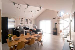 a dining room and living room with a table and chairs at Sand Valley Golf Resort in Pasłęk