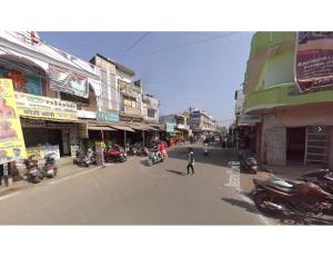 a person standing in the middle of a street with motorcycles at Bisman Lodge, Jabalpur in Jabalpur