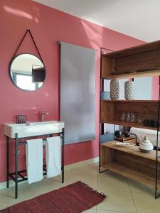 La salle de bains est pourvue d'un lavabo et d'un miroir. dans l'établissement Nest & nook, à Chios