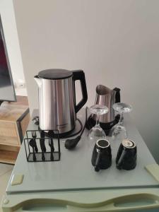a counter with a tea kettle and glasses on it at Nest & nook in Chios