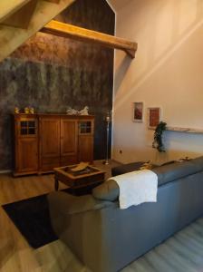 a living room with a couch and a table at Ferienwohnung zum Getreidelager in Schwarzenbach an der Saale +4 photos