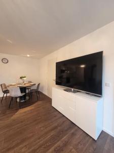 a living room with a large television and a table at Winterberg Appartement 21128 in Winterberg