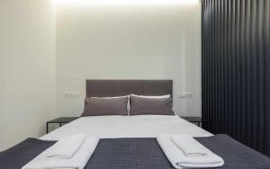 a bedroom with a large bed with two towels on it at AT Presidente Nº1 apartamento privado completo in Seville