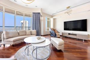 a living room with a couch and a tv at Superhost Sea View Spacious 202 square meters apartment luxury property in Dubai