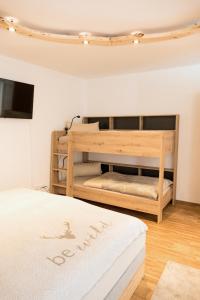 a bedroom with a bed and a wooden bunk bed at Appartement Rehlein in Mauterndorf