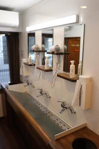 a bathroom with two sinks and a mirror at JAM HOSTEL Hakata Station Front in Fukuoka +65 photos