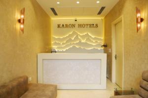 a living room with a large screen television in a room at Karon Hotels - Lajpat Nagar in New Delhi